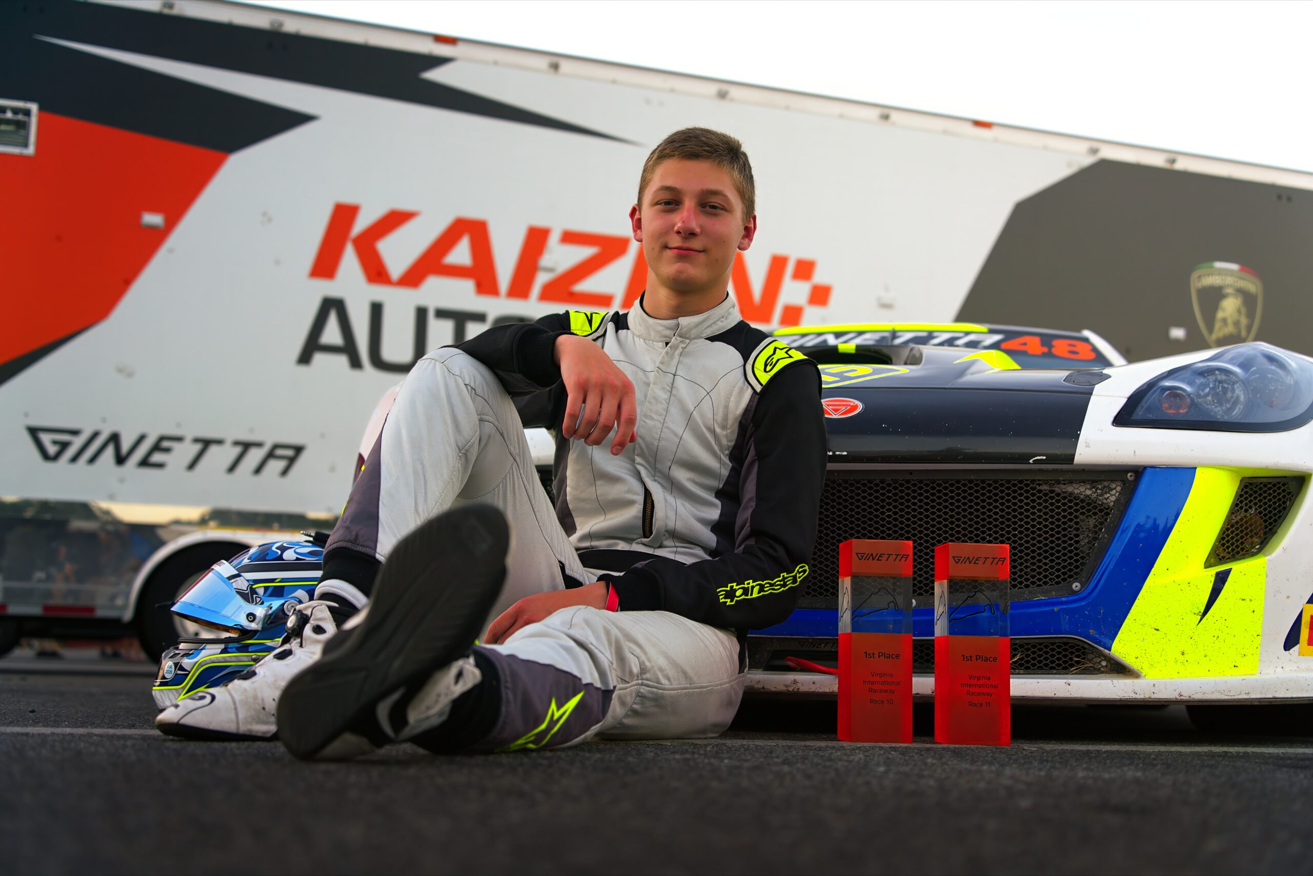 Talon Laney at the Ginetta Challenge North America at Virginia International Raceway with his two P1 trophies.